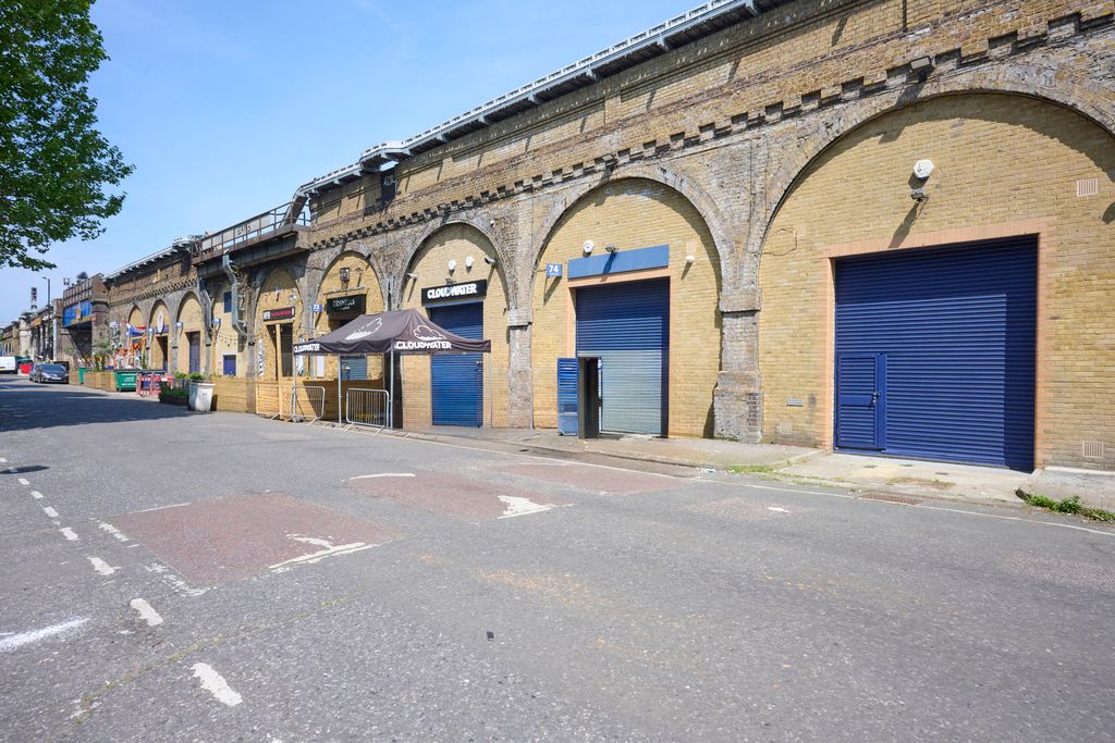 Property photo 2 of 4 An Estate, With Multiple Arches Next To Each Other. The Arches Have Closed Electric Roller Shutter Entrances.