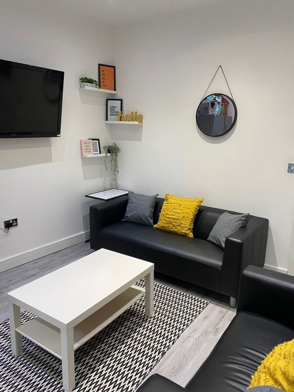 Property photo 3 of 21 A Cozy Living Room Featuring A Stylish Black Sofa ...