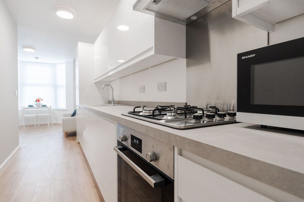 Property photo 2 of 4 Bright Modern Galley Kitchen With Integrated Appli...