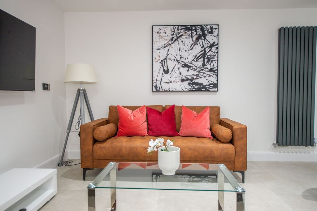 Property photo 2 of 6 Modern And Stylish Living Room Featuring A Comfort...