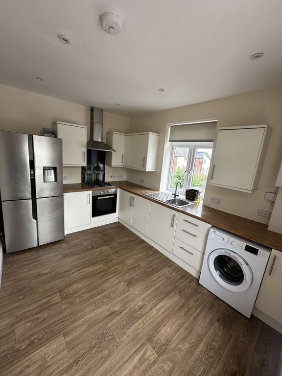 Property photo 3 of 11 A Modern Kitchen Featuring Ample Counter Space, Sl...