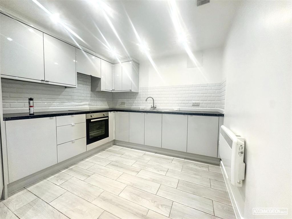 Property photo 3 of 9 Bright Modern Kitchen With Sleek White Cabinets...