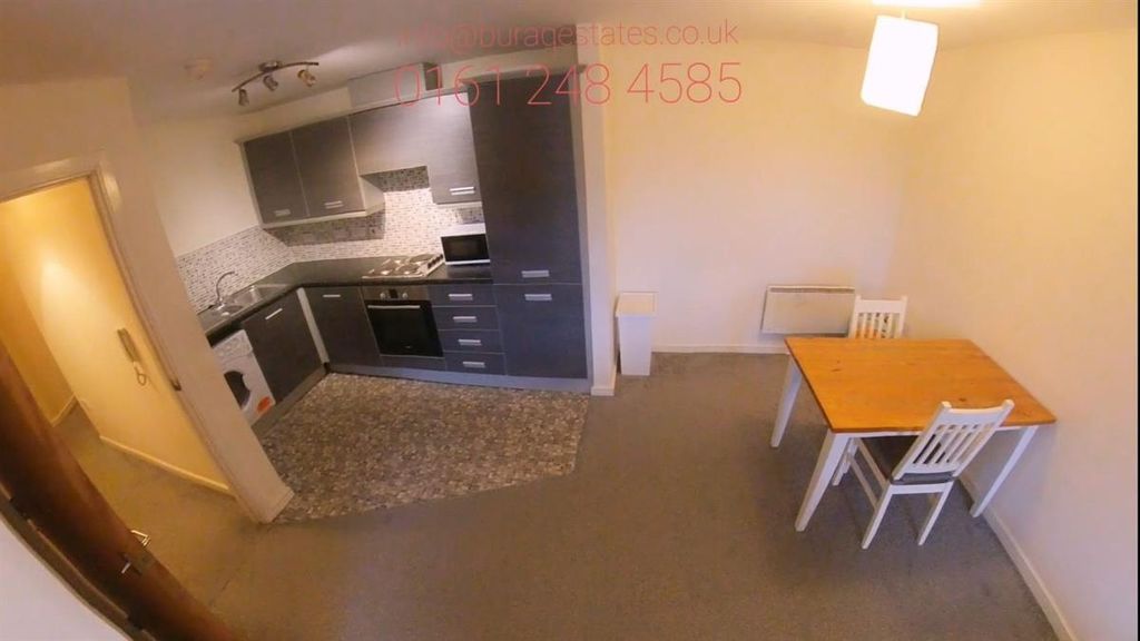 Property photo 3 of 10 Modern Open-Plan Kitchen Area With Dark Cabinetry,...