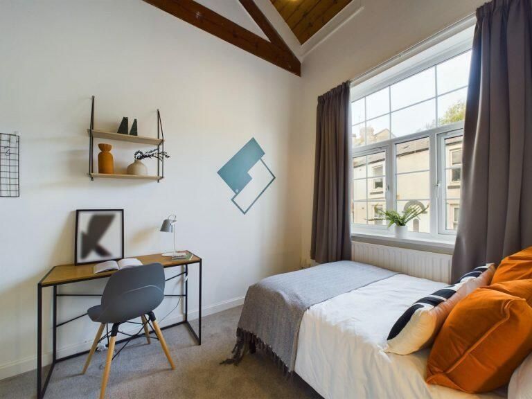 Property photo 3 of 9 A Bright And Cozy Bedroom Featuring A Comfortable ...