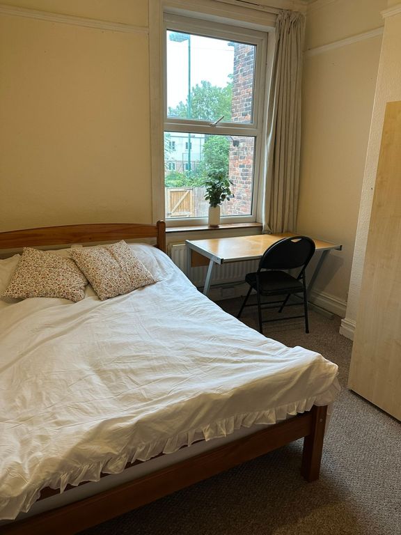 Property photo 2 of 17 A Cozy Double Bedroom Featuring A Wooden Bed With ...