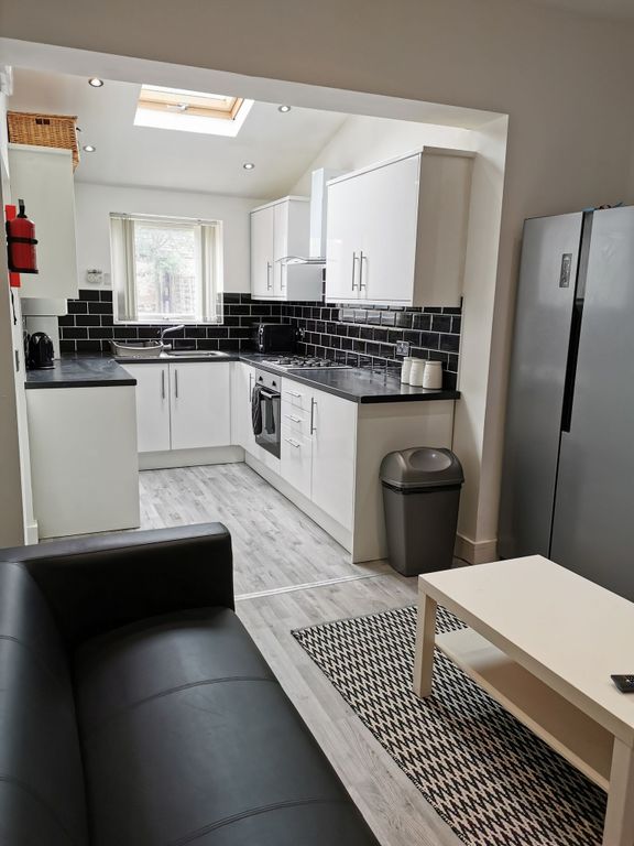 Property photo 1 of 21 Modern Kitchen Featuring Sleek Black And White Des...