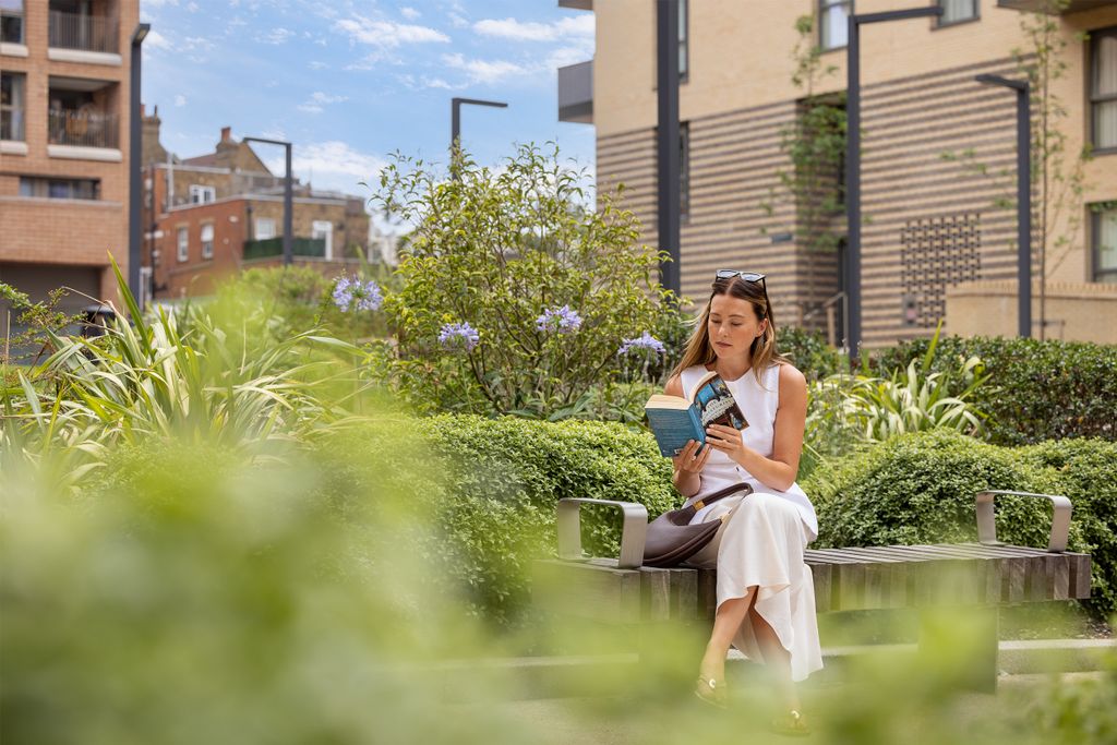 Property photo 2 of 7 Girl Reading Book On Bench Outside