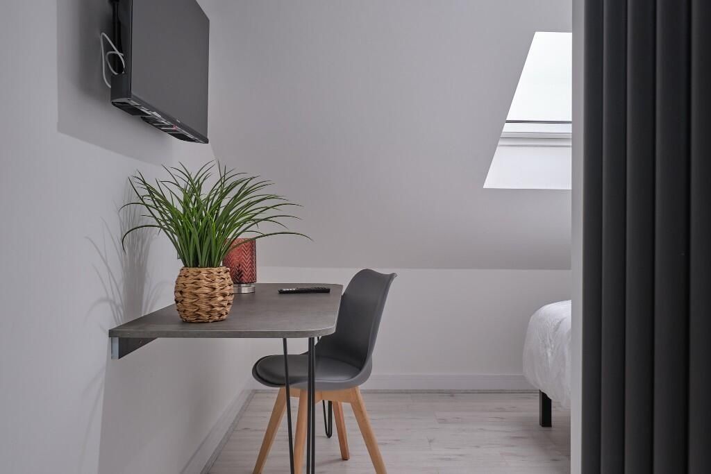 Property photo 1 of 12 Bright And Modern Master Bedroom Featuring A Cozy ...