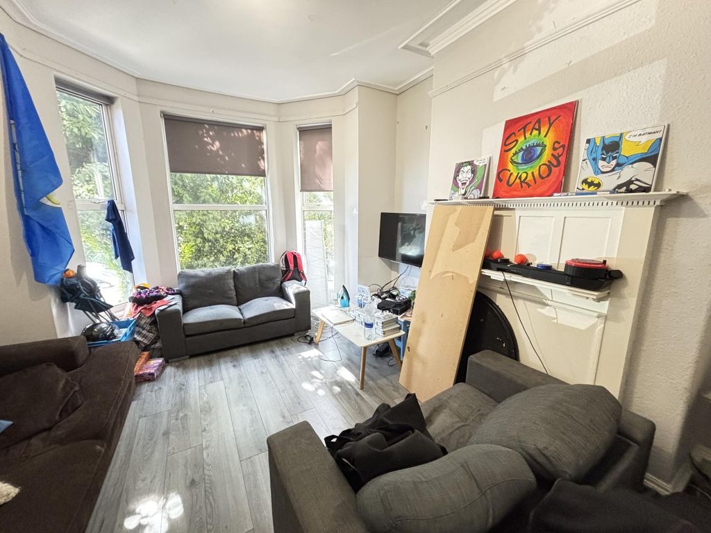 Property photo 2 of 10 A Bright And Airy Living Room Featuring Large Wind...