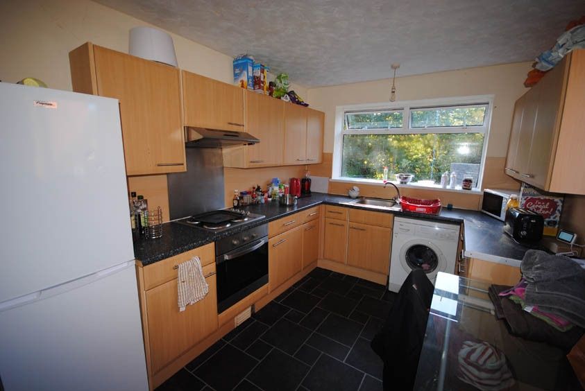 Property photo 2 of 5 A Well-Lit Kitchen Featuring Wooden Cabinetry, Mod...