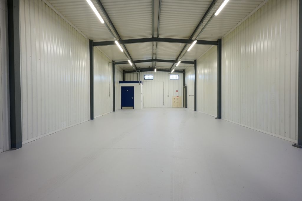 Property photo 1 of 4 The Interior Of A Warehouse Unit, Facing The Front Electric Roller Shutter, Which Is Closed And Large Enough For Vehicle Access.