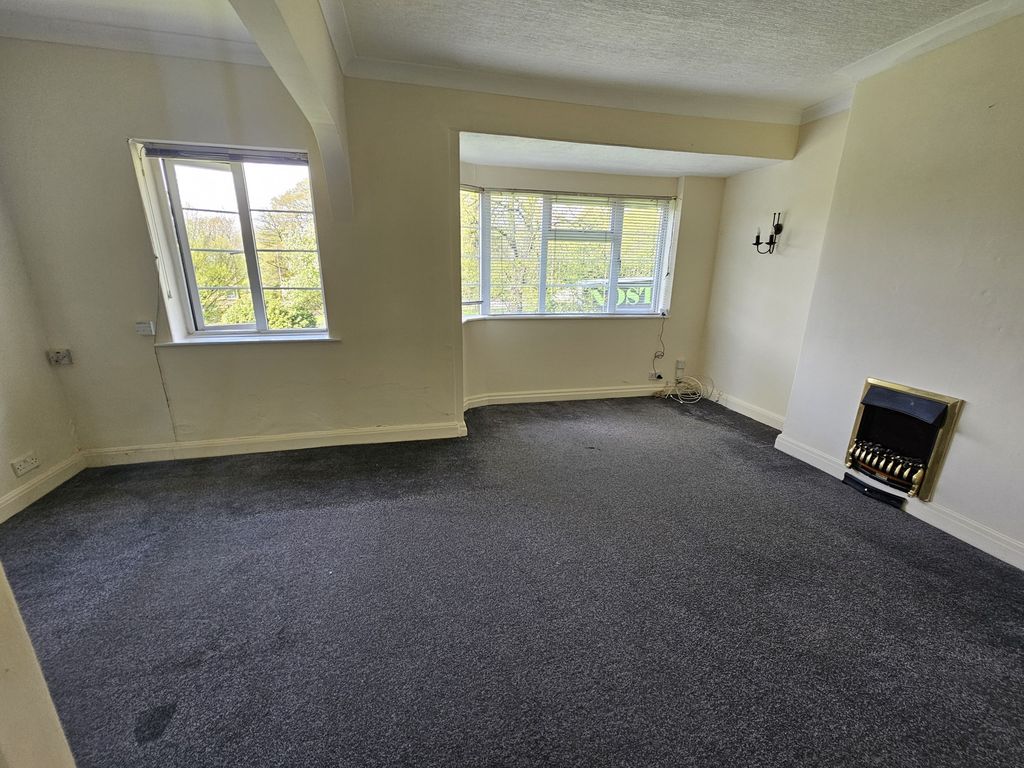 Property photo 1 of 7 A Spacious Living Room Featuring Large Windows Tha...