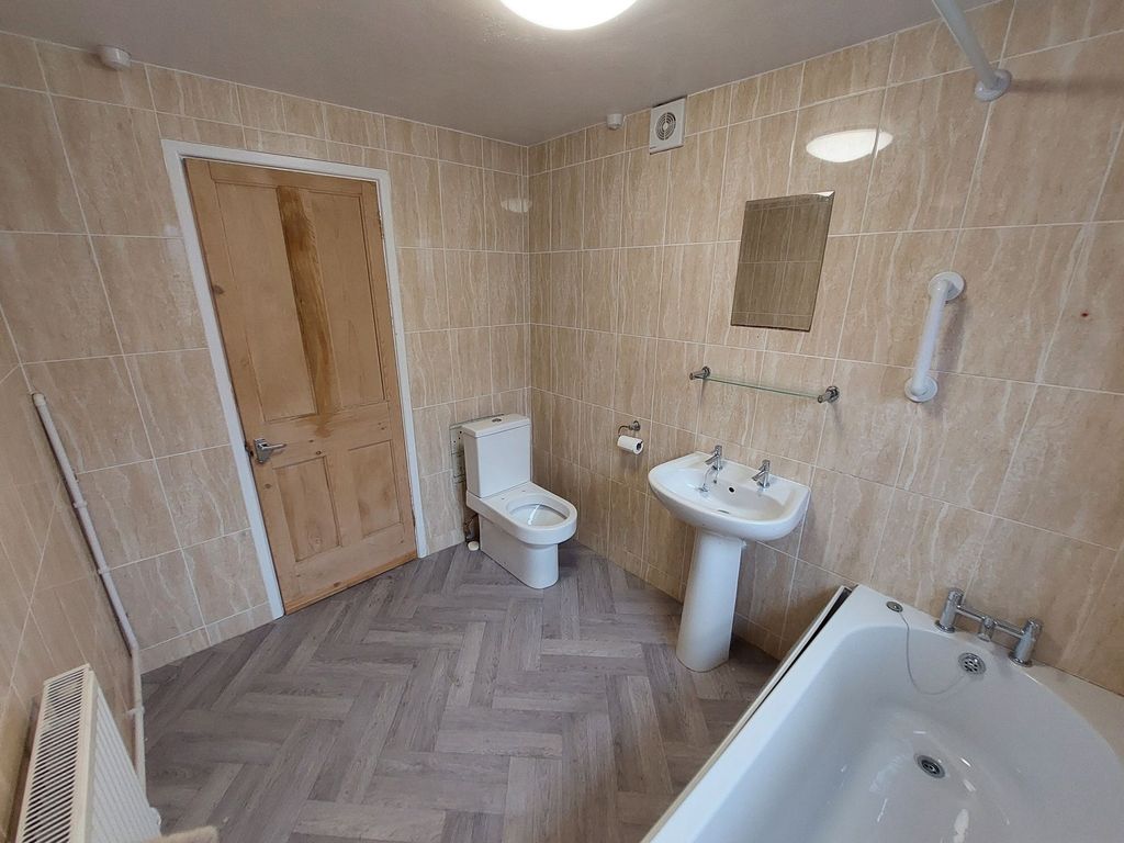 Property photo 3 of 6 Bright, Tiled Bathroom With A Modern White Bathtub...