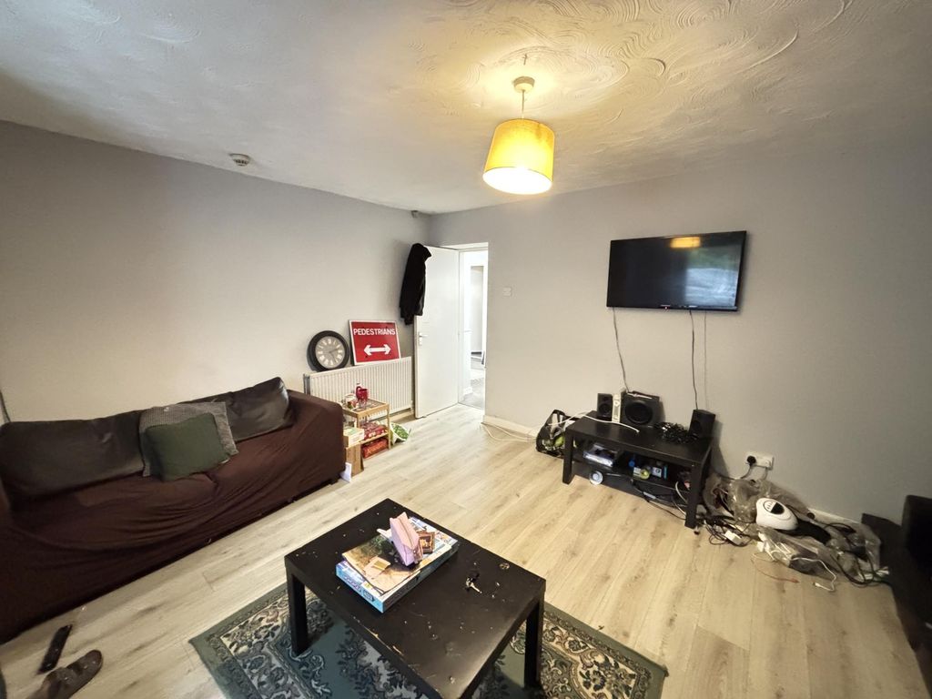 Property photo 1 of 15 A Modern, Well-Lit Living Room Featuring A Comfort...