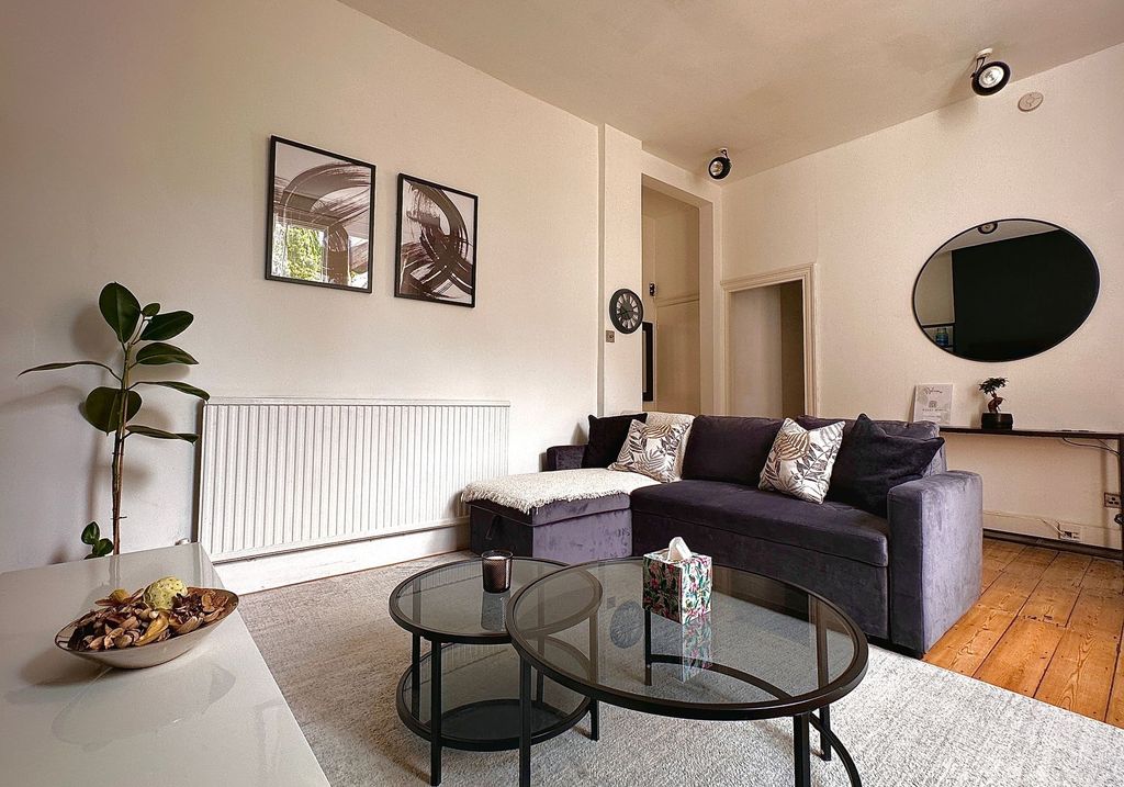 Property photo 3 of 11 A Cozy And Stylish Living Room Featuring A Plush d...