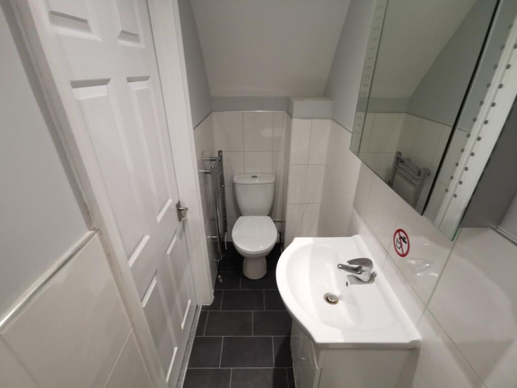 Property photo 2 of 8 Pristine Modern Cloakroom With Sleek Tiling...