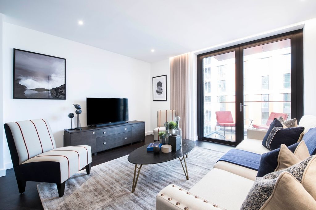 Property photo 3 of 15 This Contemporary Living Room Features A Stylish d...