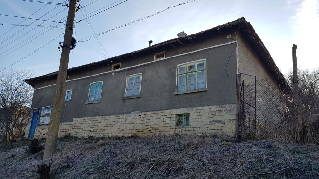 Property photo 2 of 39 Side Perspective Of The House Showing Stone Foundation And Plastered Walls With Several Windows And A Blue Door