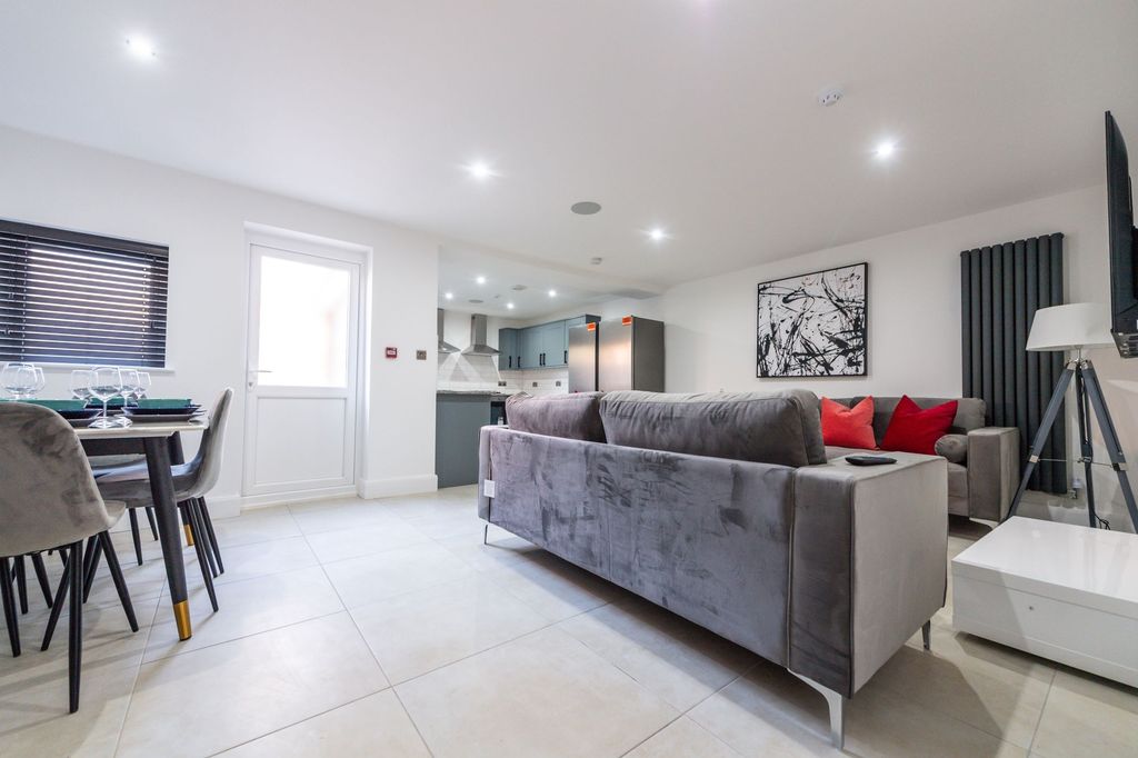 Property photo 1 of 12 A Modern And Spacious Living Room Featuring A Larg...