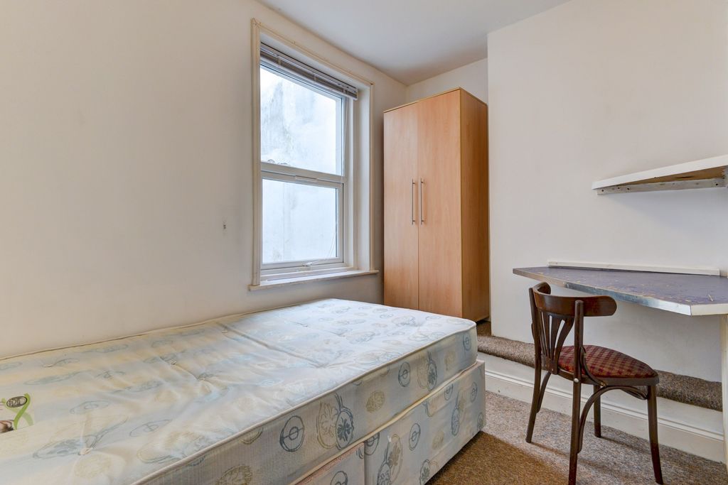 Property photo 1 of 25 Bright And Simple Bedroom Featuring A Large Window...