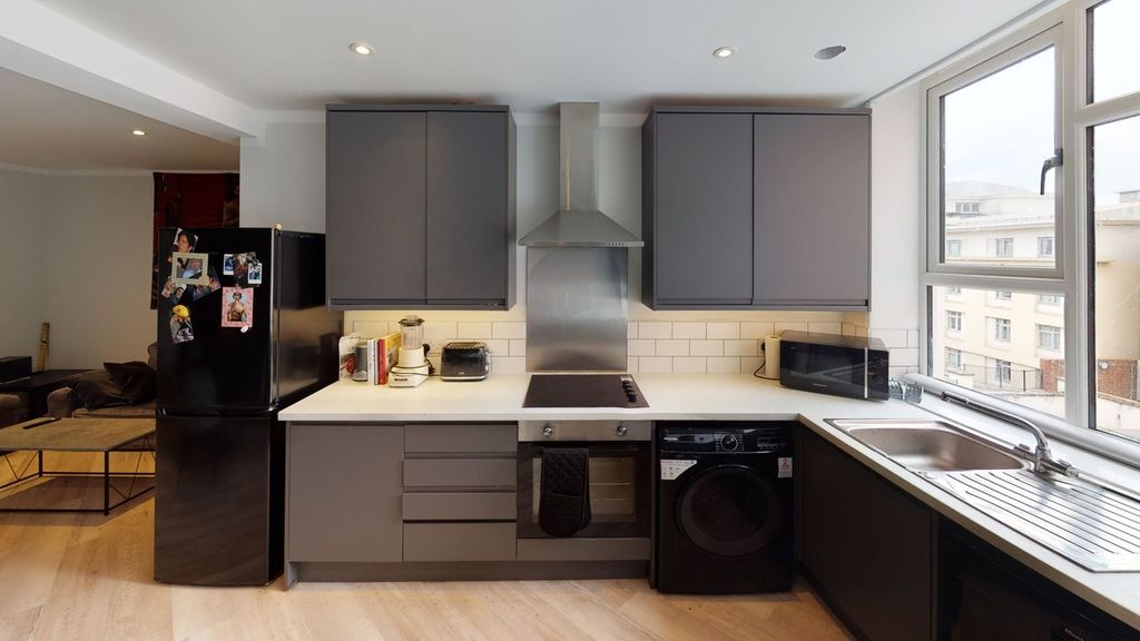 Property photo 3 of 6 A Modern And Bright Kitchenette Featuring Sleek Ca...