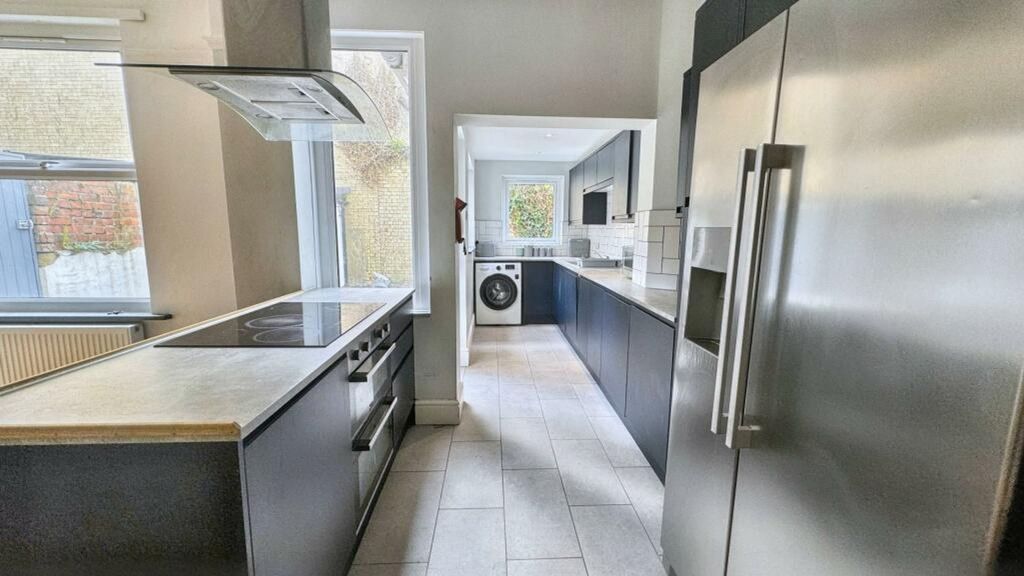 Property photo 3 of 11 A Spacious And Modern Kitchen With Ample Natural l...
