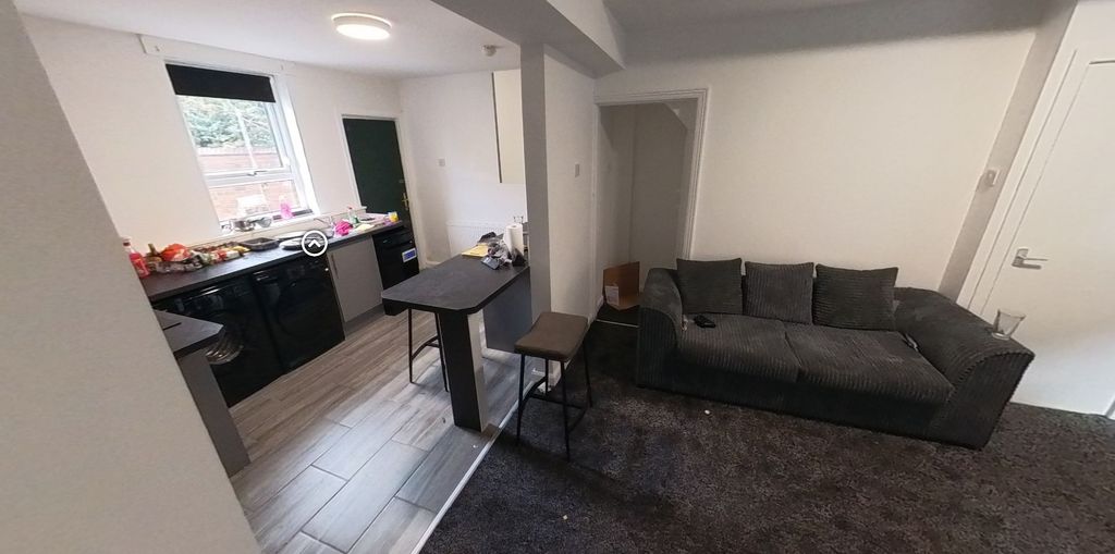 Property photo 2 of 5 A Modern Living Room With Ample Natural Light, Fea...