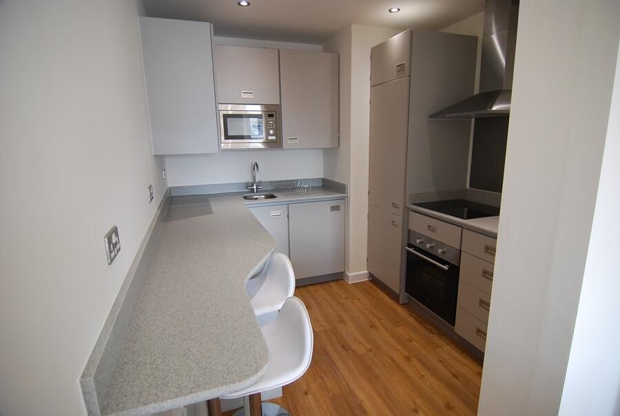 Property photo 2 of 4 A Modern Kitchen Featuring Sleek White Cabinetry, ...