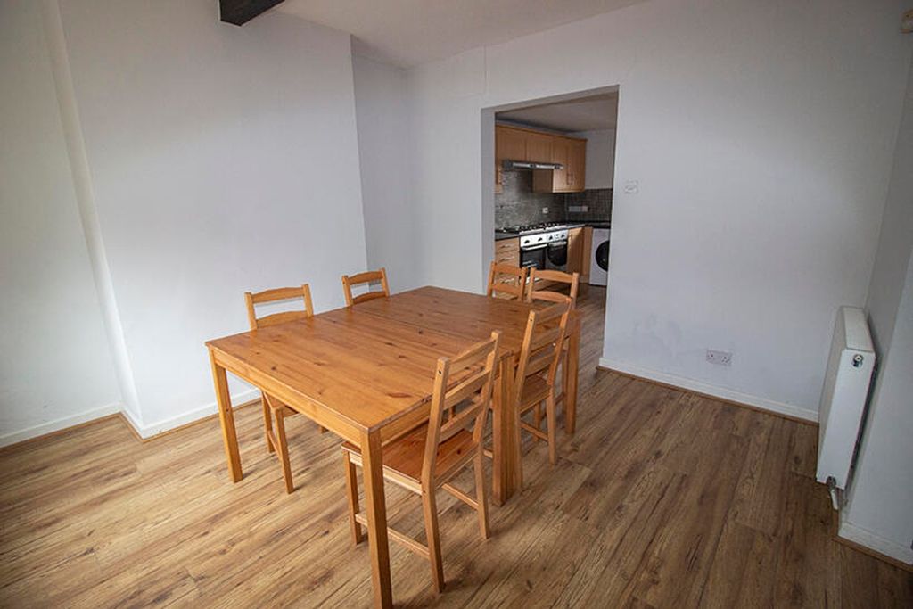 Property photo 2 of 5 Spacious Kitchen Area Featuring A Wooden Dining Ta...