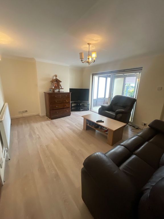 Property photo 3 of 7 A Cozy Living Room Featuring Comfortable Dark Leat...