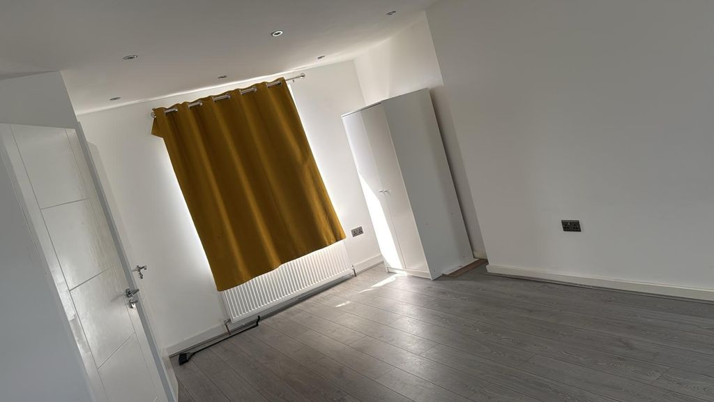 Property photo 1 of 6 Bright Bedroom With Sleek Wood-Style Flooring...