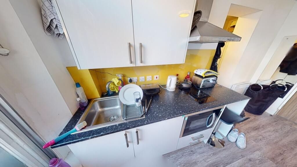 Property photo 3 of 4 This Modern Kitchen Features A Sleek Design With A...