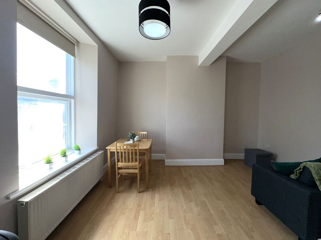 Property photo 2 of 8 A Bright And Tidy Living Room Featuring Light Wood...