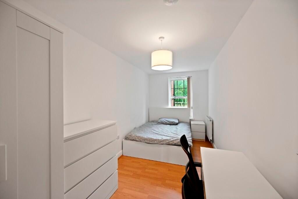 Property photo 1 of 8 A Neat And Simple Bedroom Featuring A Comfortable ...