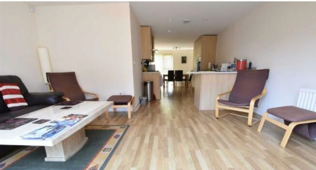 Property photo 2 of 9 A Bright And Inviting Living Room With Wooden Floo...