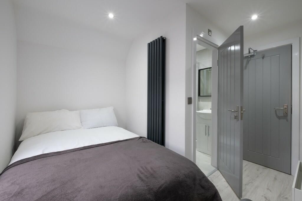 Property photo 3 of 13 A Clean And Modern Bedroom Featuring A Comfortable...
