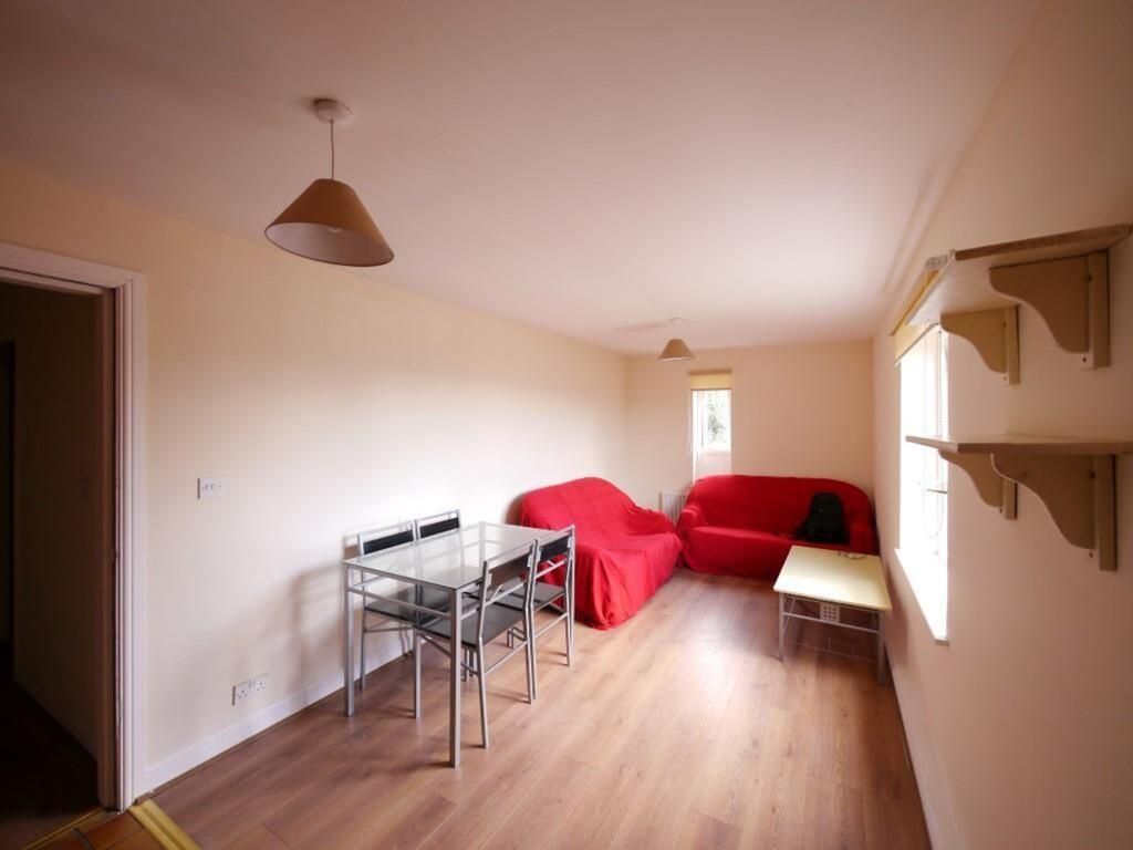 Property photo 3 of 7 A Cozy Living Room With Natural Light Streaming Th...