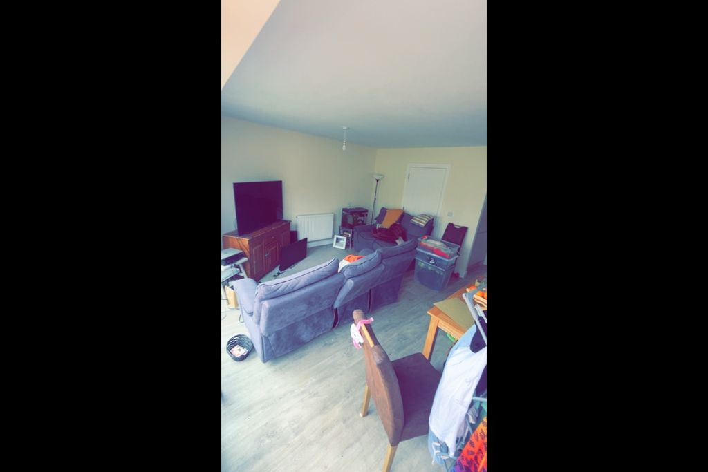 Property photo 3 of 5 Bright, Casual Living Room With A Large TV On A Wo...