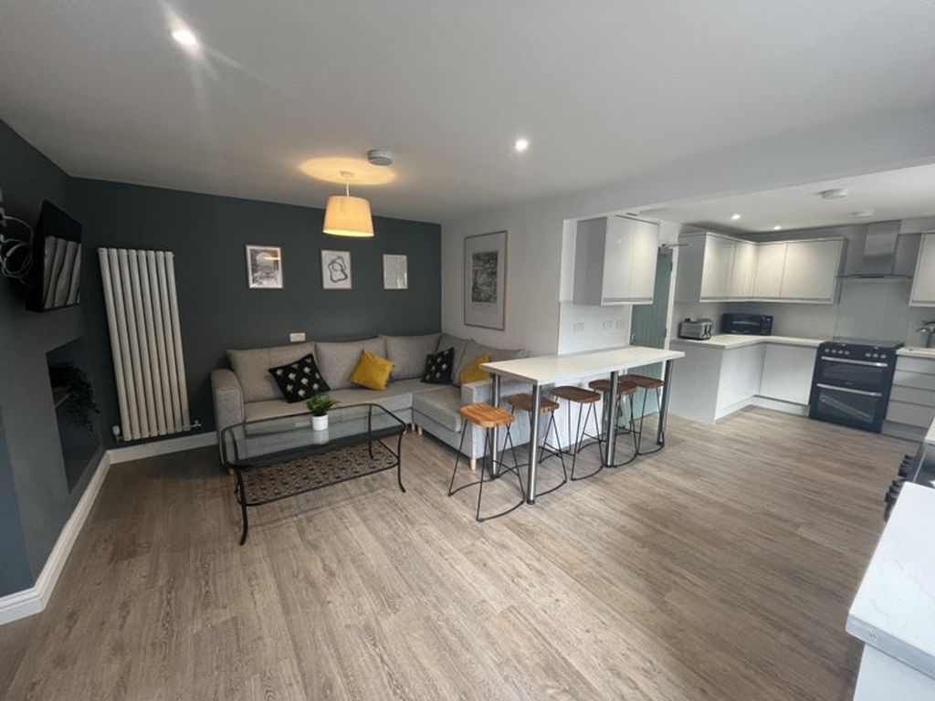 Property photo 2 of 6 A Bright And Inviting Living Room Featuring A Comf...