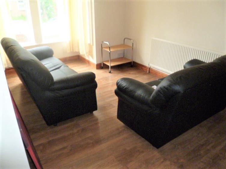 Property photo 3 of 22 A Cozy Living Room Featuring Two Comfortable Black...