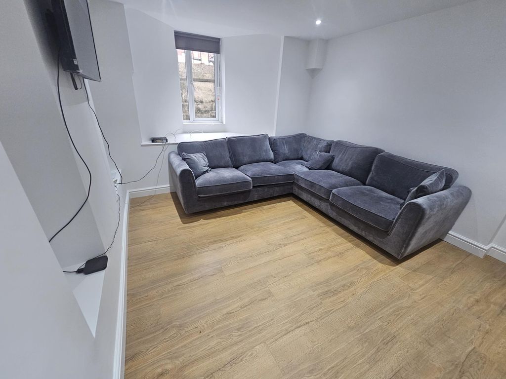 Property photo 2 of 22 A Bright And Spacious Living Room Featuring A Comf...