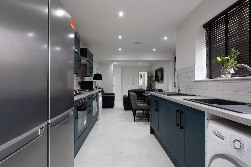 Property photo 2 of 13 A Modern Kitchen Featuring Sleek Cabinetry In A De...