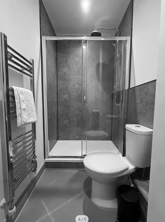 Property photo 2 of 5 A Sleek And Modern Bathroom Featuring A Spacious S...