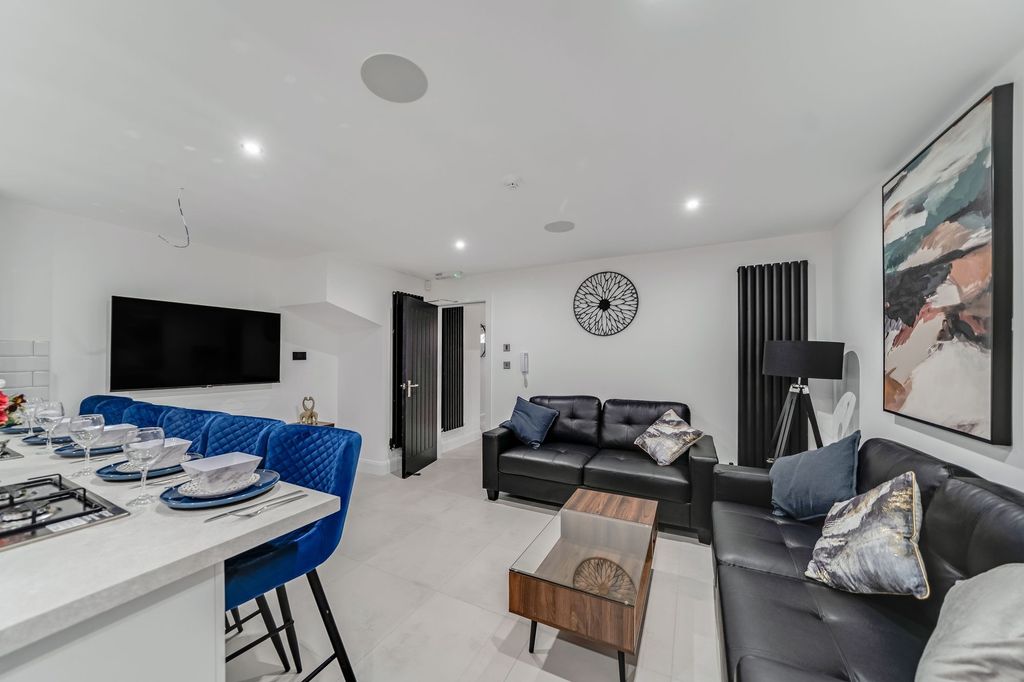 Property photo 2 of 5 Bright And Stylish Living Room Featuring Modern Bl...