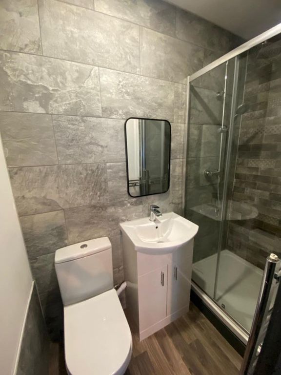 Property photo 3 of 6 This Modern Bathroom Features Sleek Gray Tiles, An...