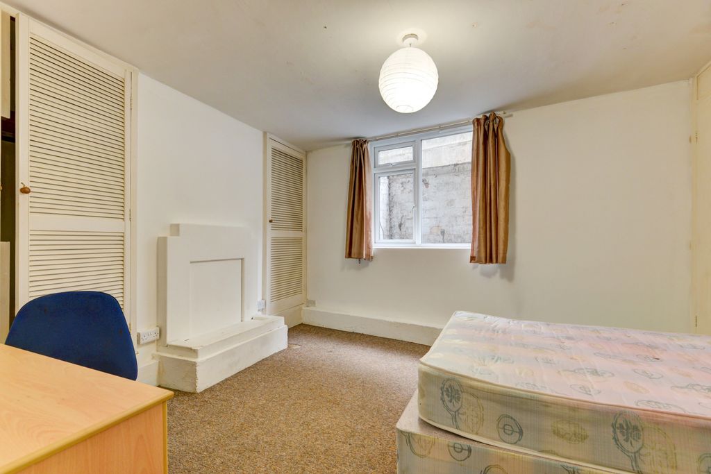 Property photo 3 of 25 A Simple, Clean Bedroom Featuring A Single Bed And...