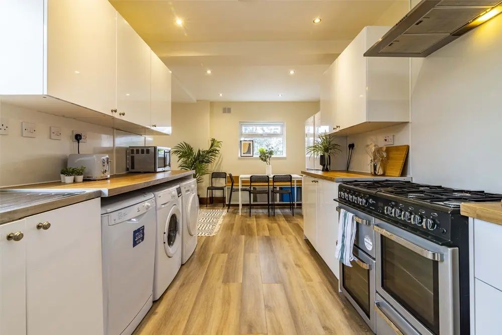 Property photo 1 of 10 Bright And Modern Kitchen Featuring Ample Countert...
