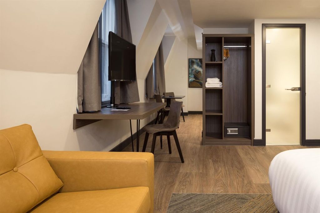 Property photo 3 of 10 Stylish Master Bedroom With Desk And Cozy Seating...