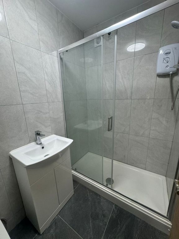 Property photo 3 of 27 Modern Tiled Bathroom With A Glass-Enclosed Shower...