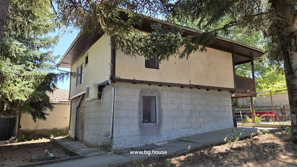 Property photo 3 of 100 View Of The Rear Corner Of The House Showing Concrete Block Lower Walls And Plastered Upper Walls, Partially Shaded By Tall Trees.